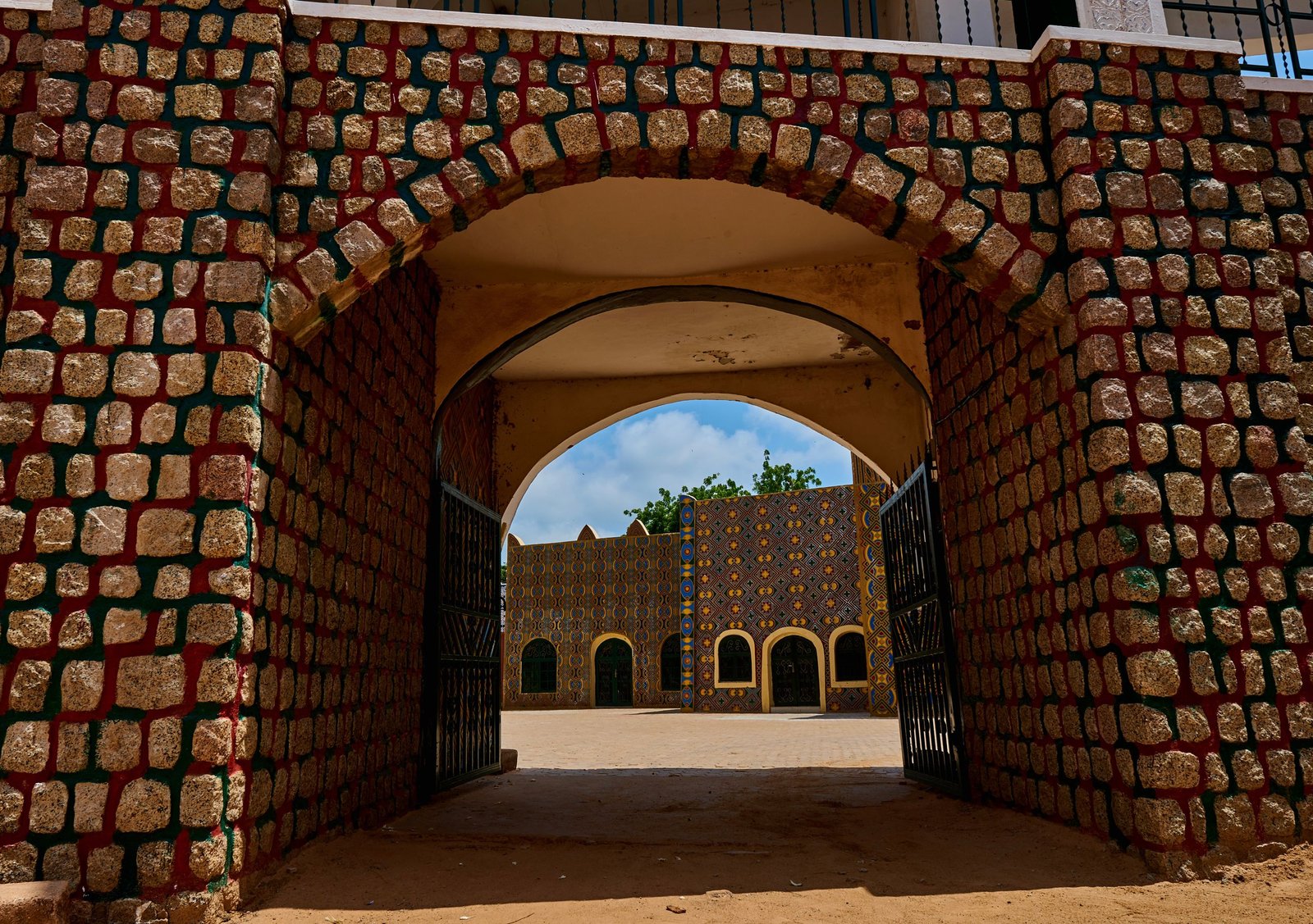 Vibrant traditional architecture at the entrance of a palace in Dutse, Nigeria.